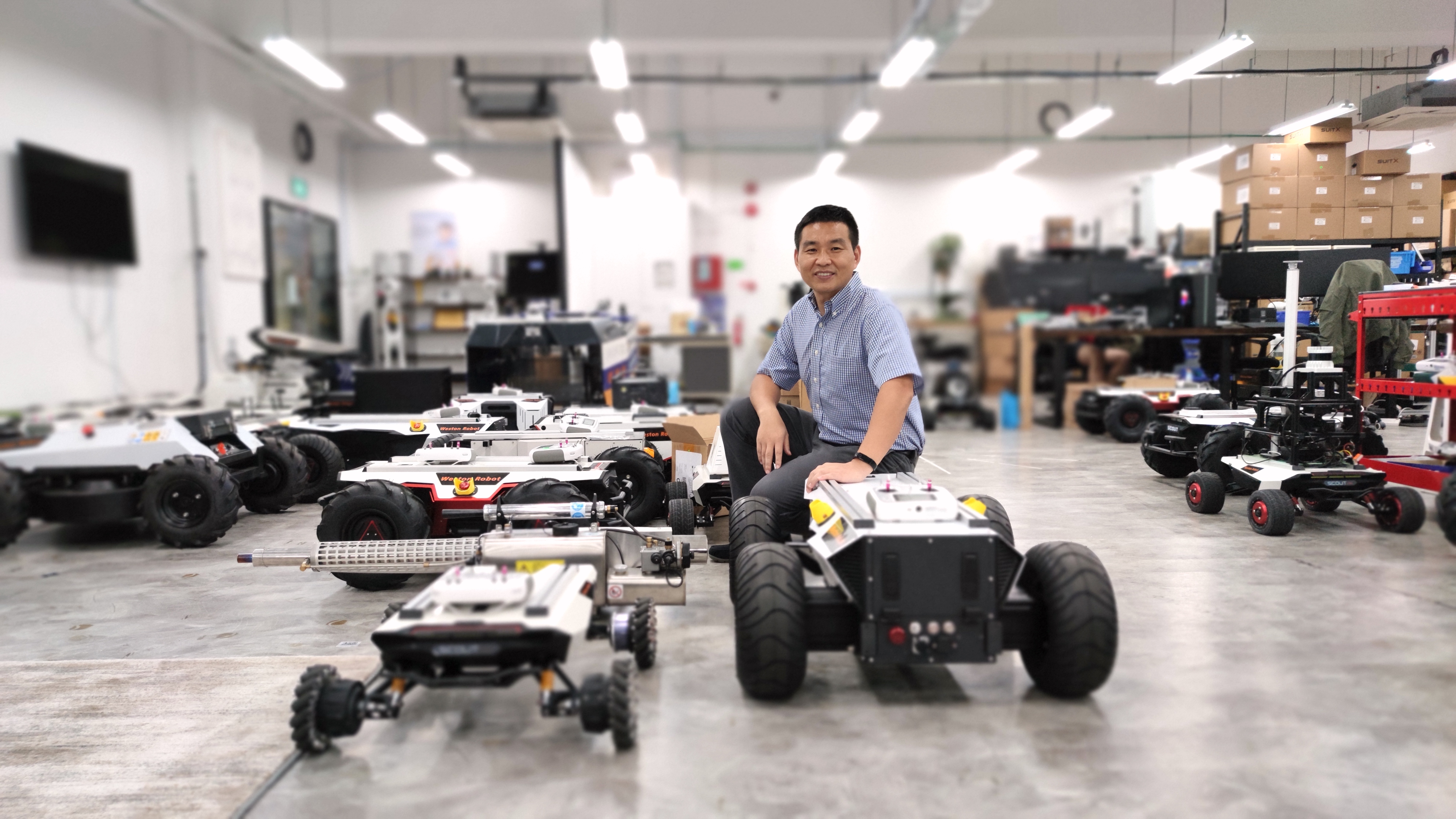 Dr Zhang with some of Weston Robot's products in their headquarters at The Chadwick at Singapore Science Park.